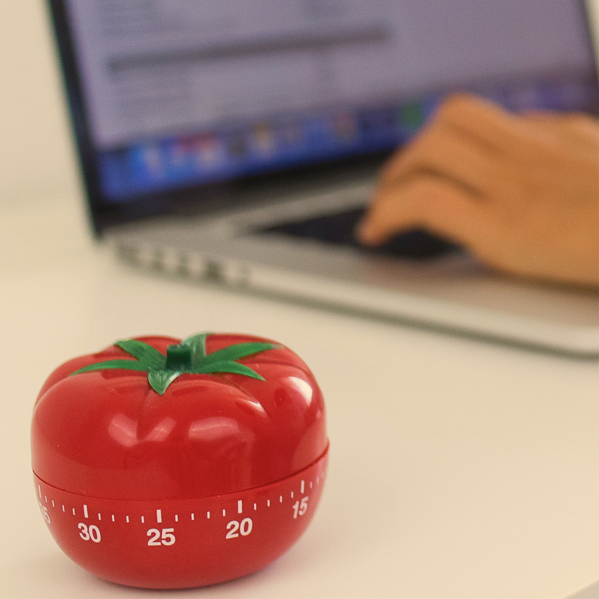 Pomodoro Timer Near Person Working On Laptop