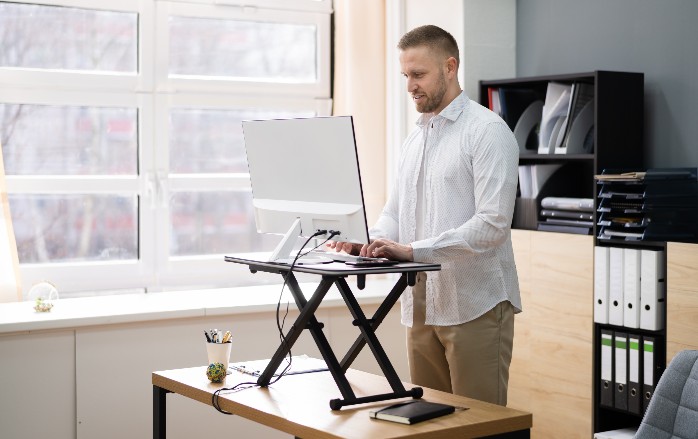 Man at desk with laptop riser