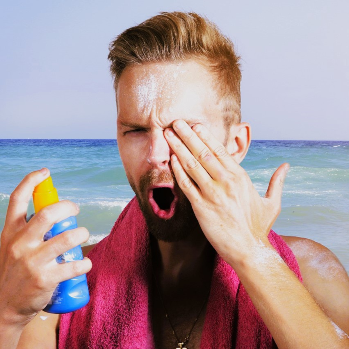 Man wincing from sunscreen in his eyes